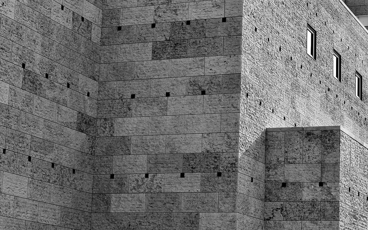 Geometric stone facade of a cultural building, photographed in black and white