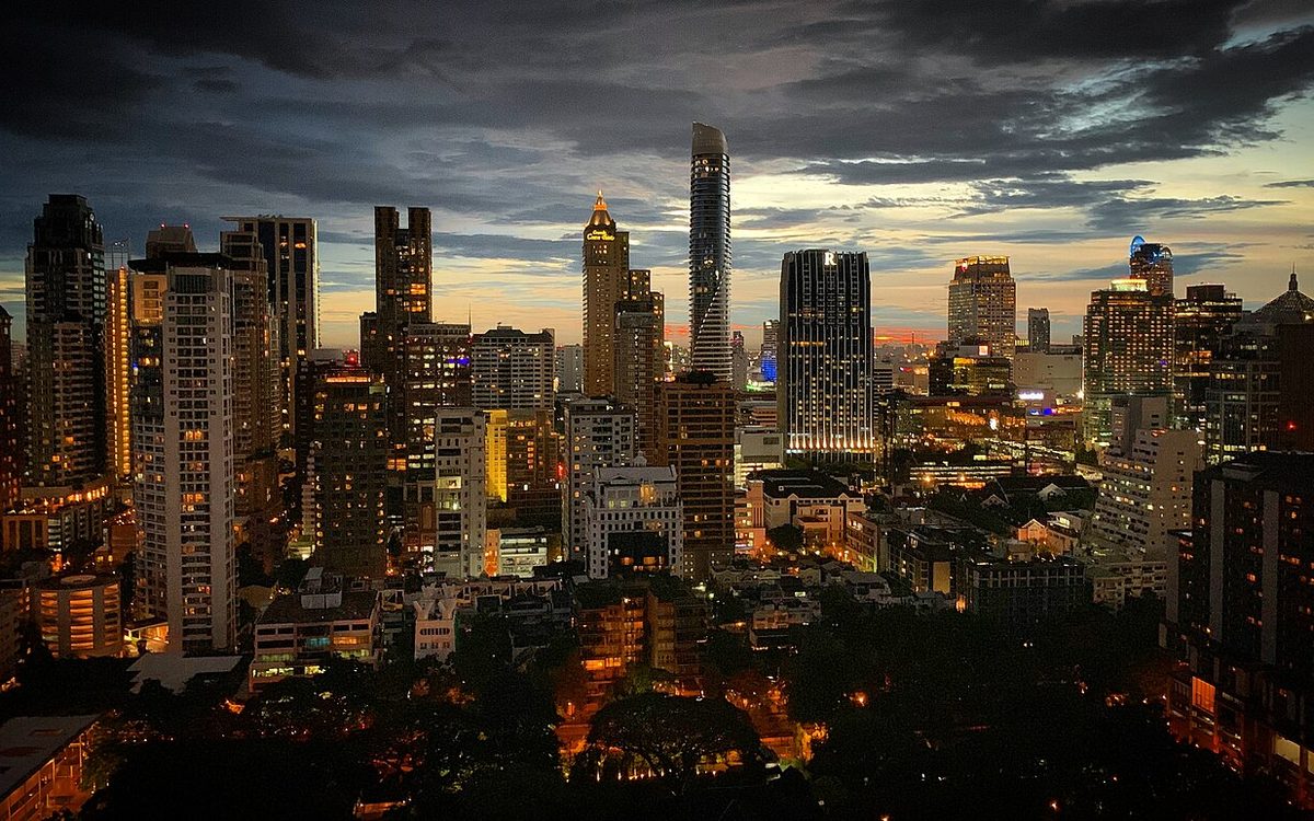 City skyline at dusk with lit high-rise towers